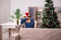 Young man celebrating Christmas alone at home Royalty Free Stock Photo