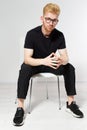 Young man on a chair, Portrait of handsome young man sitting on a chair, Proud and satisfied young man sitting on chair Royalty Free Stock Photo