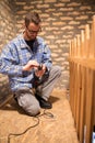 Young man changing drill bits, renovating attic Royalty Free Stock Photo