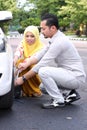 Young man changing the punctured tyre