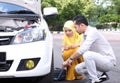 Young man changing the punctured tyre