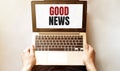 Young man checking his laptop, top view. Text GOOD NEWS Royalty Free Stock Photo