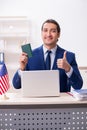 Young man checking passport at USA embassy Royalty Free Stock Photo