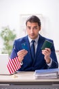 Young man checking passport at USA embassy Royalty Free Stock Photo