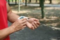 Young man checking pulse with medical after training, closeup