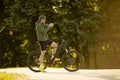 Young man checking time on ebike in nature Royalty Free Stock Photo
