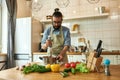 Young man, chef cook using hand blender while preparing Italian meal in the kitchen Royalty Free Stock Photo