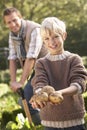 Young man with child working in garden