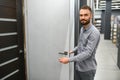 A young man chooses interroom door in the hardware store