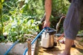 young man chooses to use termite control chemicals that are not toxic to humans mixed with water in tank for spraying to eliminate Royalty Free Stock Photo