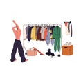 Young man choosing stylish outfit back view. Guy looks on closet, makes choice of garment on hanger rack. Wardrobe rail Royalty Free Stock Photo