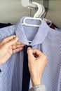 Young man choosing a tie and a shirt from the closet Royalty Free Stock Photo