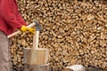 Man with axe chopping wood on a chopping block. Close-up Royalty Free Stock Photo