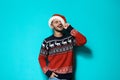 Young man in Christmas sweater and hat Royalty Free Stock Photo