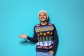 Young man in Christmas sweater and knitted hat Royalty Free Stock Photo