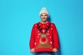 Young man in Christmas sweater and knitted hat Royalty Free Stock Photo