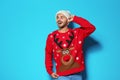 Young man in Christmas sweater and knitted hat Royalty Free Stock Photo