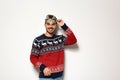 Young man in Christmas sweater with party glasses Royalty Free Stock Photo