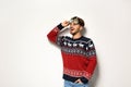 Young man in Christmas sweater with party glasses Royalty Free Stock Photo