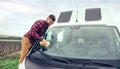 Man cleaning camper van glass outdoor Royalty Free Stock Photo