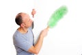 Young man cleaning with feather duster Royalty Free Stock Photo
