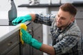 Young man cleaning kitchen Royalty Free Stock Photo