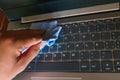 Young man cleaning laptop keyboard Royalty Free Stock Photo