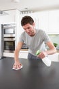 Young Man Cleaning Modern Kitchen Royalty Free Stock Photo