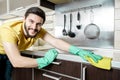 Young man cleaning modern kitchen