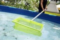 Young man cleaning a portable swimming pool Royalty Free Stock Photo