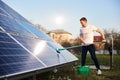 Young man cleaning solar panel Royalty Free Stock Photo
