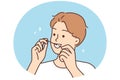Young man cleaning teeth with dental floss