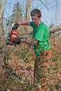 Young Man Clearing Brush with Chainsaw Royalty Free Stock Photo
