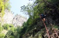 Young man climbing high stairs in the canyon