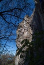 Young man climbing on a limestone wall with wide valley on the background Royalty Free Stock Photo