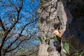 Young man climbing on a limestone wall with wide valley on the background Royalty Free Stock Photo