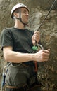 Young man climbing on a limestone wall with wide valley on the background Royalty Free Stock Photo