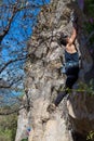 Young man climbing on a limestone wall with wide valley on the background Royalty Free Stock Photo