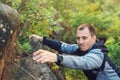 Young man climbing the mountain ridge. Rock climbing, mountain climbing, hiking. Lifestyle, love to mountains. Hiker man on a rock Royalty Free Stock Photo