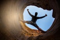 Young man climbing the mountain ridge