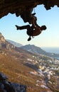 Young man climbing on roof of cave Royalty Free Stock Photo