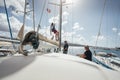 Young man climbing sailboat mast for doing some reparations