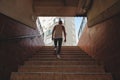 Young man climbing stairs in pedestrian subway Royalty Free Stock Photo