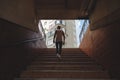 Young man climbing stairs in pedestrian subway Royalty Free Stock Photo