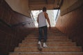 Young man climbing stairs in pedestrian subway Royalty Free Stock Photo