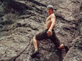 Young man climbing on stone rock, bouldering Royalty Free Stock Photo