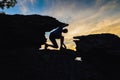 Young man climbing on top of rock mountain Royalty Free Stock Photo