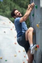 young man climbing wall in gym Royalty Free Stock Photo