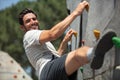 young man climbing wall rock outdoors Royalty Free Stock Photo