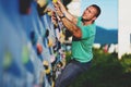 Young man climbing wall rock outdoors Royalty Free Stock Photo